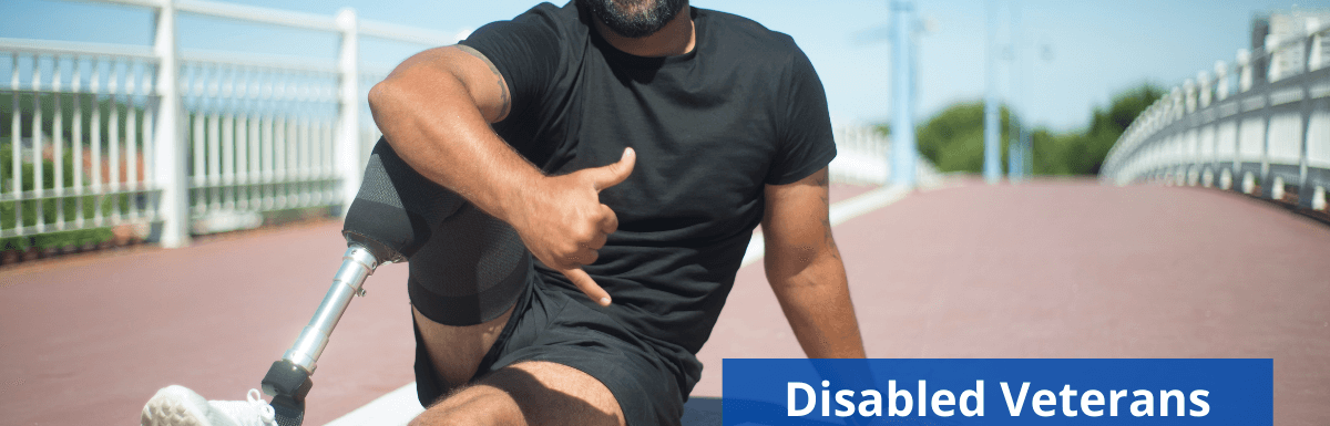 Image of a veteran with a prosthetic leg sitting on a running track making the "hang loose" gesture with his hand while smiling. Disabled Veterans Resources is the title located on the bottom right corner. The Woods and Woods logo is in the top left corner.