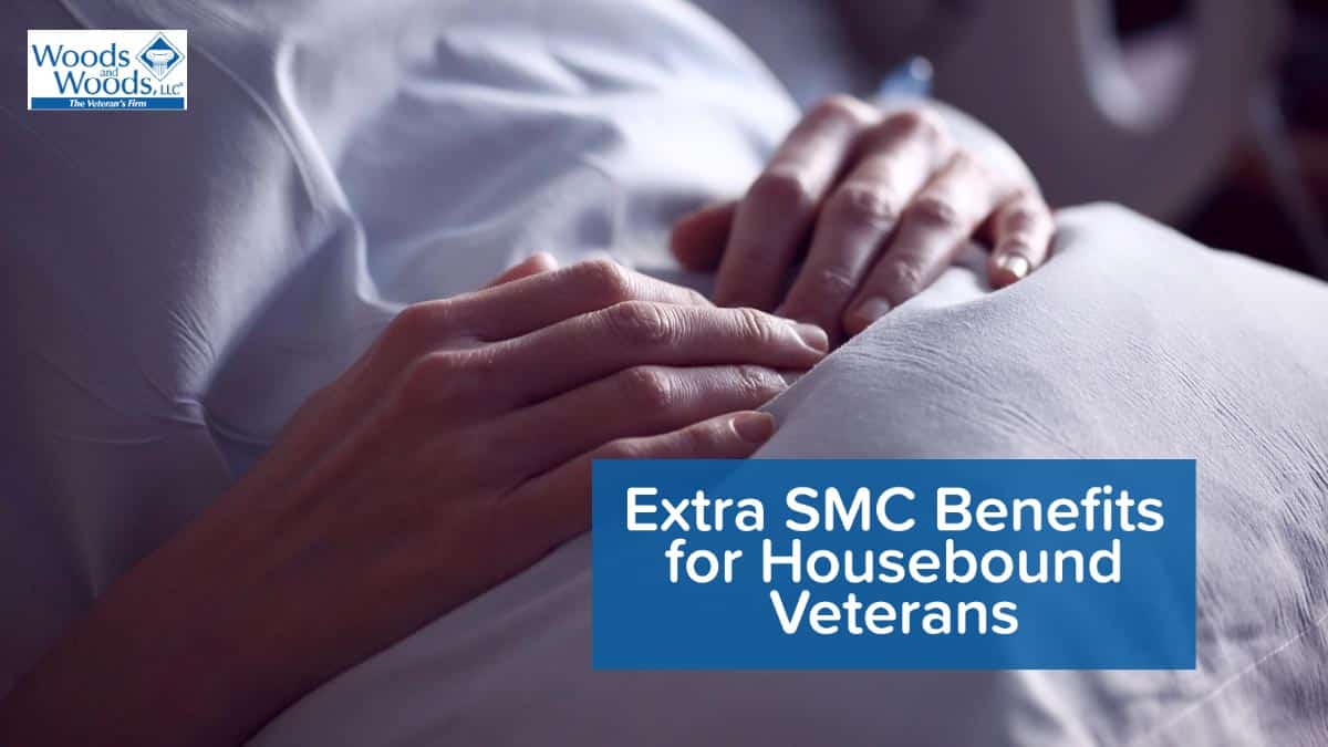Picure of a close-up on hands of a person lying in his or her bed with the Woods and Woods logo in the top left and our title on the bottom right: Extra SMC Benefits for Housebound Veterans
