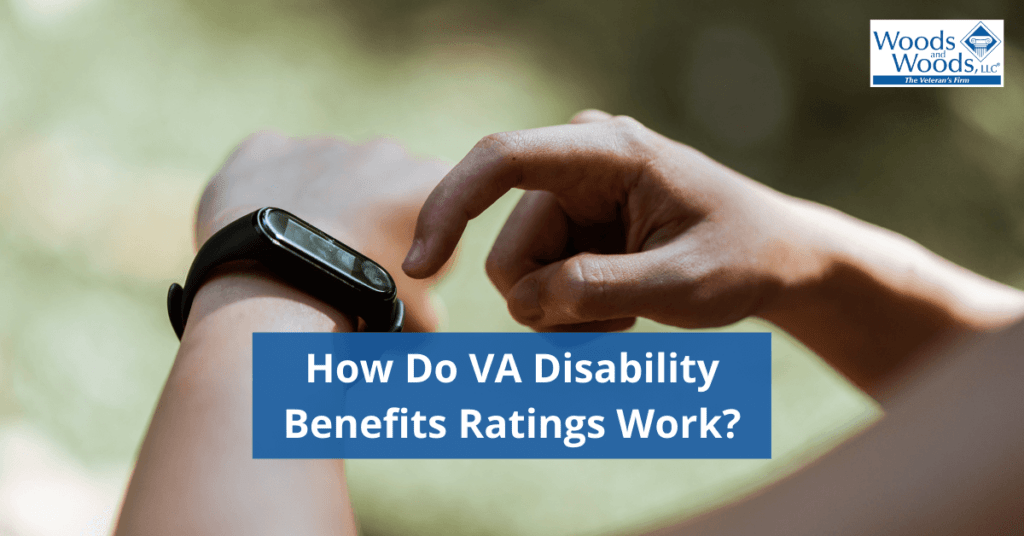 Image of someone's hands using a smart watch outdoors. Our title: How Do VA Disability Ratings Work? is in the lower center and the Woods & Woods logo is in the upper right corner.