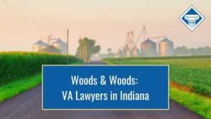 Picture of a road with the view of American midwest farmland in the background. Article title across the bottom: Woods & Woods: VA Lawyers in Indiana