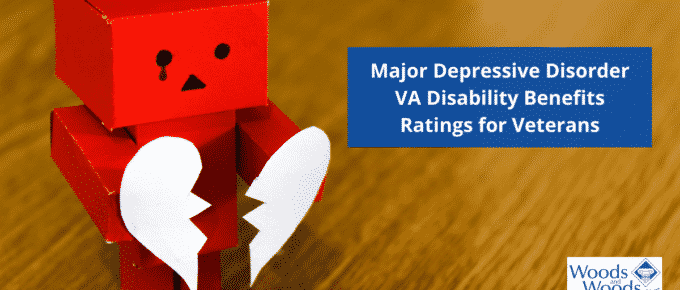 Image of a red cardboard cartoon person with a sad face holding a white paper heart that has been torn in half. Major Depressive Disorder VA Disability Benefits Ratings for Veterans is the title located in the upper right corner. The Woods and Woods logo is in the bottom right corner.