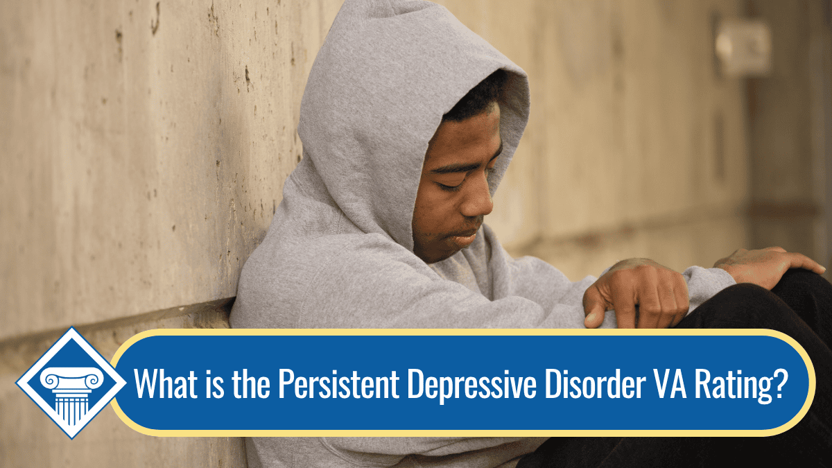 An image of a man sitting against a wall, looking down with the grey hood of his sweatshirt up over his head. Along the bottom of the image is a banner reading the article title: What is the persistent depressive disorder VA rating