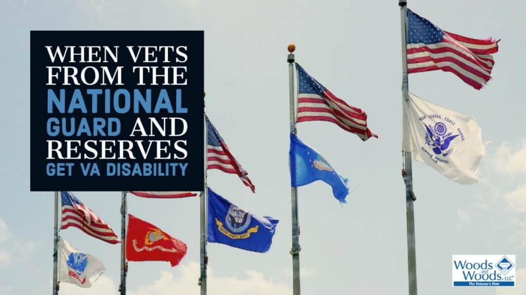 Picture of American Flags flying above flags from the Army, Navy, Air Force, Marines, and Coast Guard. Our Woods and Woods logo is in the bottom right and our title is in the top left: When Vets From the National Guard and Reserves Get VA Disability