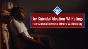 A man sits in the darkness, on the ground, leaned against a piece of furniture and staring away from the camera. over the image is a red box reading the article title: The suicidal ideation VA rating: how suicidal ideation affects VA disability