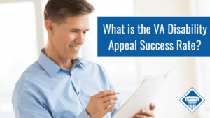 Photo of a man wearing a light blue button up smiling while looking at a piece of paper he is holding in his hand. Article title is to the right: "What is the VA Disability Appeal Success Rate?"