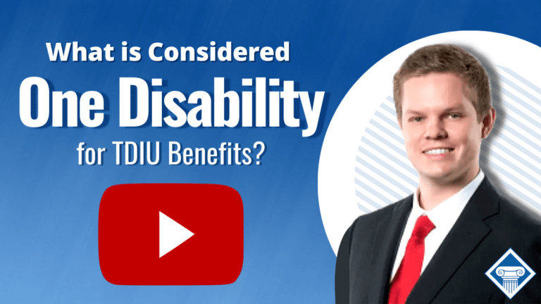 A lawyer in a suit and red tie is on the right side. In the middle is a red Youtube play button, and above that is the article title: What is considered one disability for TDIU benefits?