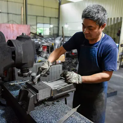 A man works with a milling machine.