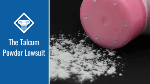 Image of talcum powder bottle tipped over, with talcum powder spilled out on a black background. The title of the article reads, "The Talcum Powder Lawsuit" is in a blue box on the left side of the image.