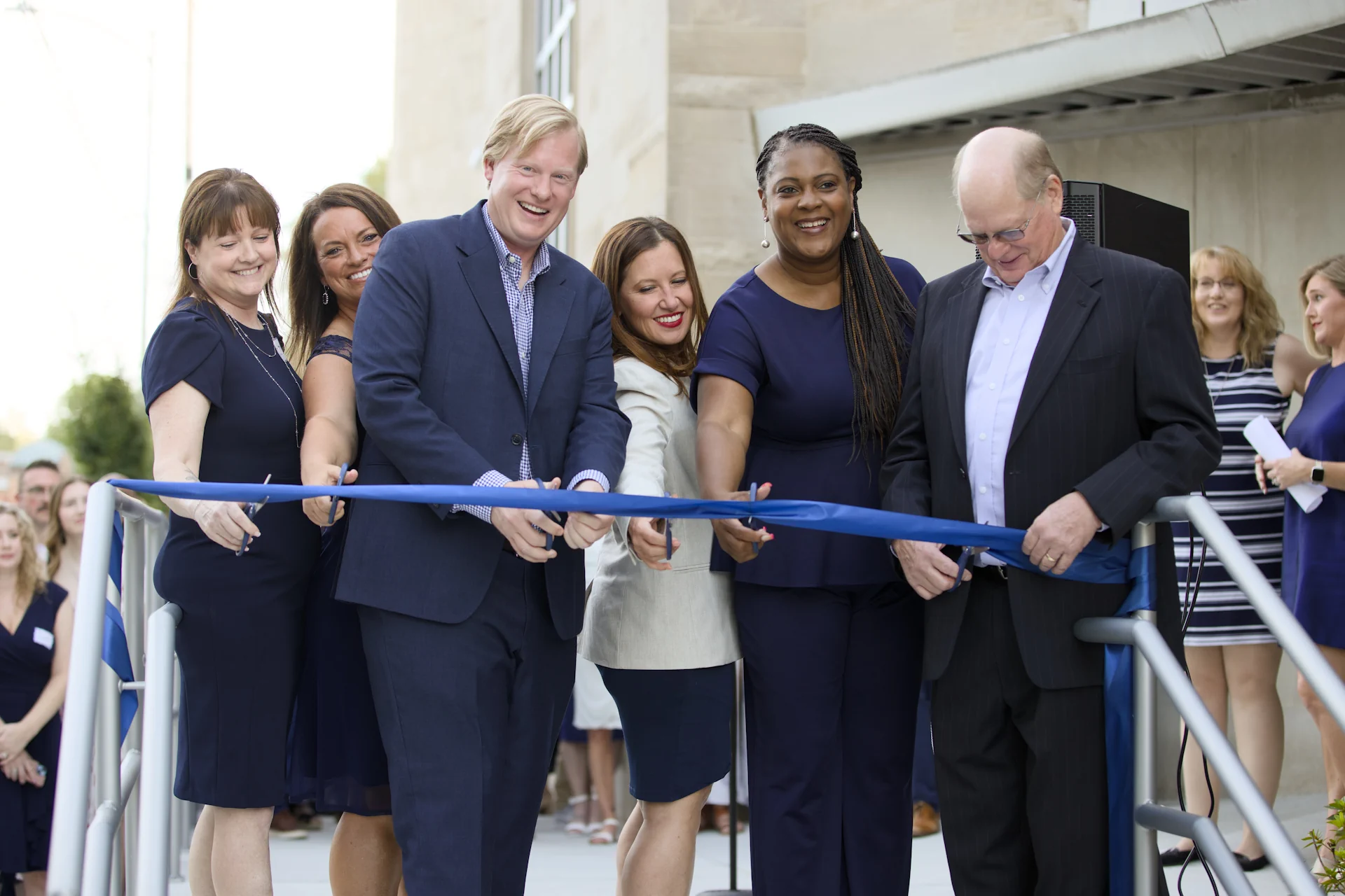 Neil Woods, Mike Woods, Evansville Mayor Stephanie Terry, Lori Underwood, Jill Rager, and Sara Hatch cut the ribbon officially opening the firm's new office.