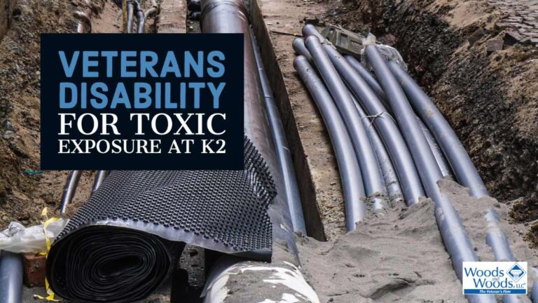 Picture of pipes and conduits lying in the mud at a construction site with our title over the top left: Veterans Disability for Toxic Exposure at K2